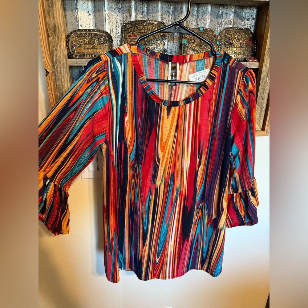 Colorfully beautiful blouse with 3/4. bell sleeves.